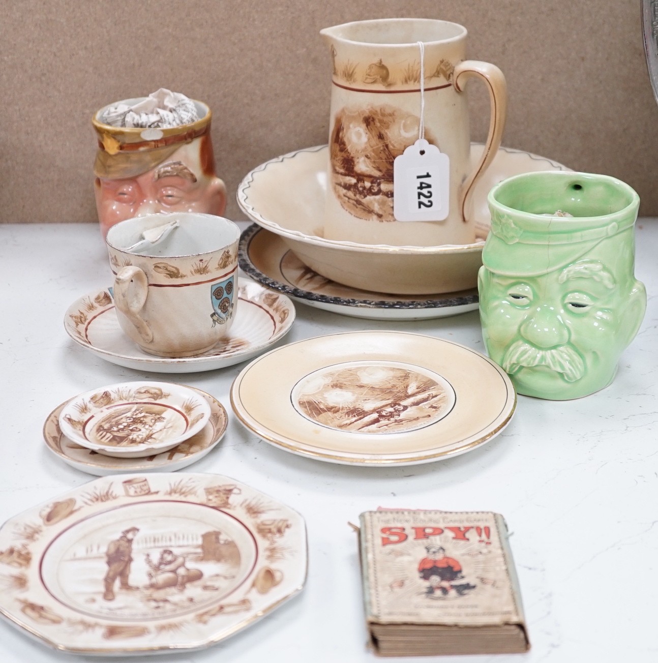 WWI commemorative Grimwades ‘Old Bill’ ceramics, including a jug, a bowl, five various dishes and a moustache cup and saucer, together with two novelty character jugs and a spy card game